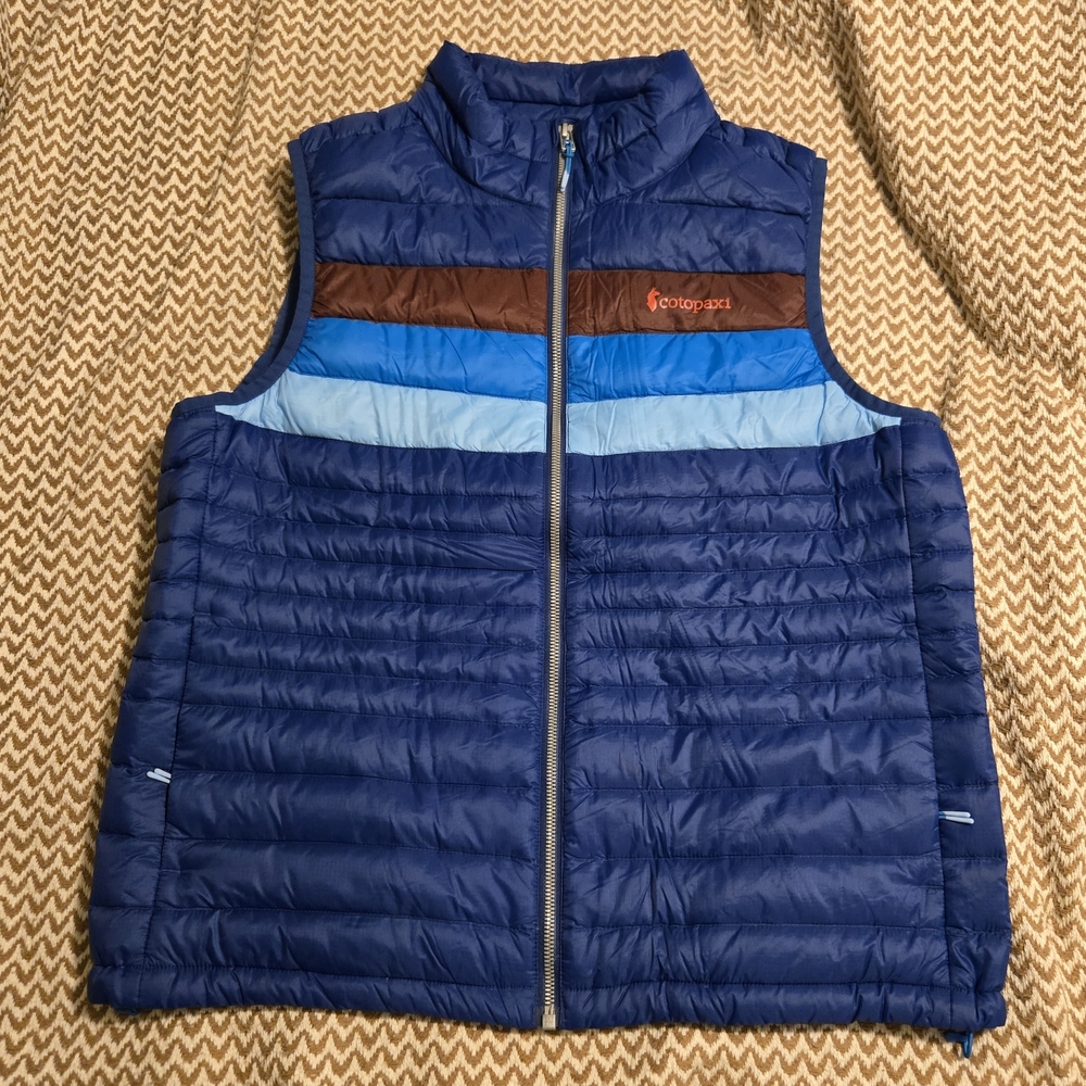 cotopaxi Navy Blue Puffer Vest with Light & Bright Blue Stripes and Brown Accent